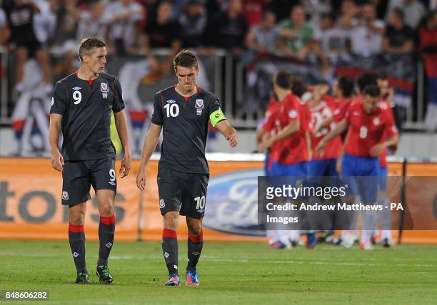 Wales' Aaron Ramsey and Steve Morison look dejected after Serbia's Branislav Ivanovic scores his side's fifth goal during the 2014 FIFA World Cup...