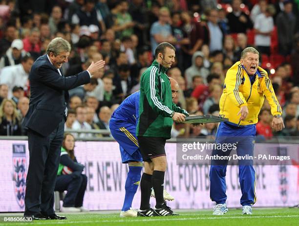 Ukraine manager Oleg Blokhin and England manager Roy Hodgson gesture on the touchline