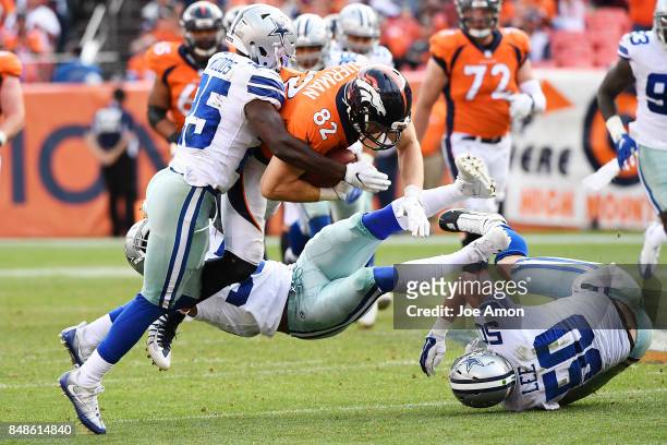Jeff Heuerman of the Denver Broncos is tackled by Xavier Woods of the Dallas Cowboys, Kavon Frazier , and Sean Lee during the third quarter on...