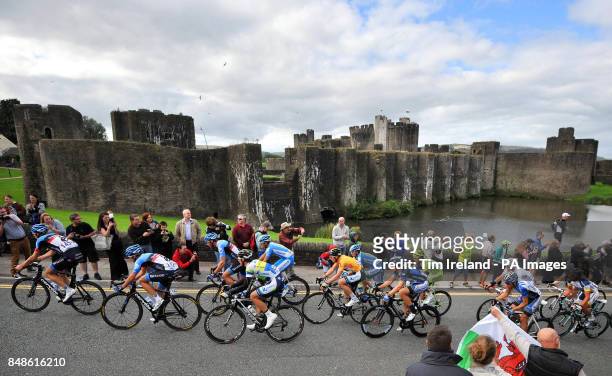 Riders make their way past Caerphilly Castle during the sixth stage of the Tour of Britain in Caerphilly.