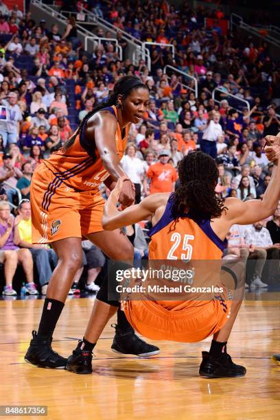 Camille Little of the Phoenix Mercury helps up Monique Currie of the Phoenix Mercury during the game against the Los Angeles Sparks in Game Three of...