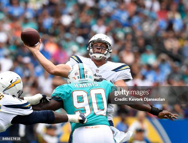 Quarterback Philip Rivers of the Los Angeles Chargers throws under pressure by defensive end Charles Harris of the Miami Dolphins during the first...
