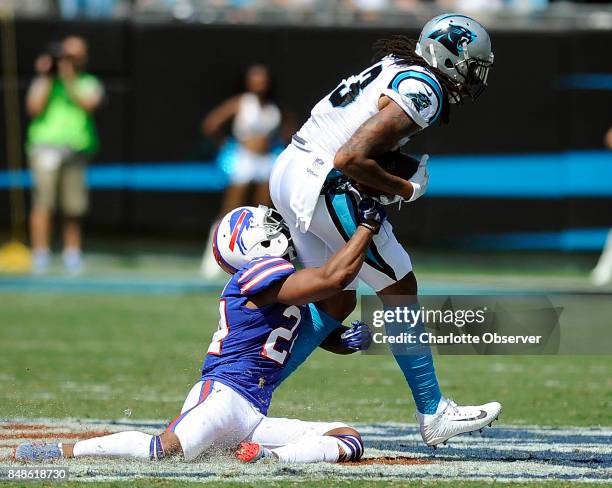 Carolina Panthers wide receiver Kelvin Benjamin makes a reception past Buffalo Bills defensive back Leonard Johnson in the first half on Sunday,...