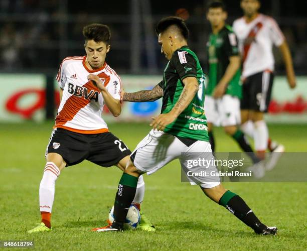 Matias Moya of River Plate fights for the ball with Emiliano Aguero of San Martin during a match between San Martin de San Juan and River Plate as...