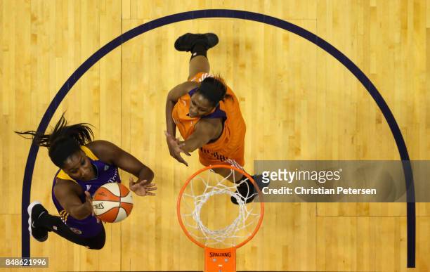 Jantel Lavender of the Los Angeles Sparks lays up a shot past Camille Little of the Phoenix Mercury during the first half of semifinal game three of...