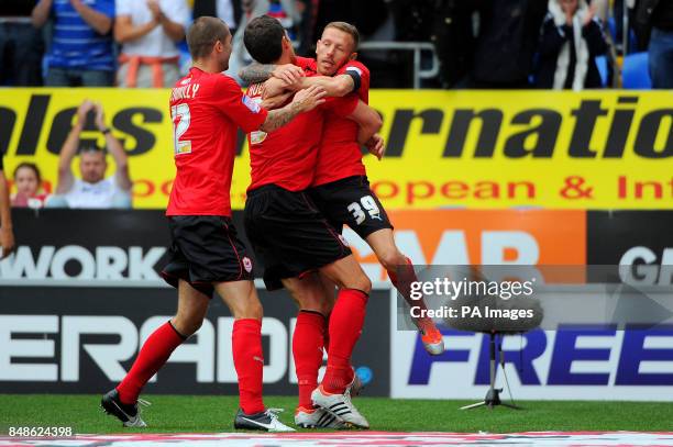 Cardiff's Craig Bellamy celebrates scoring a goal from a free kick with team mates Mark Hudson and Matthew Connolly during the npower Football League...