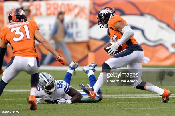 Chris Harris of the Denver Broncos intercepts a ball intended for Dez Bryant of the Dallas Cowboys during the third quarter on Sunday, September 17,...