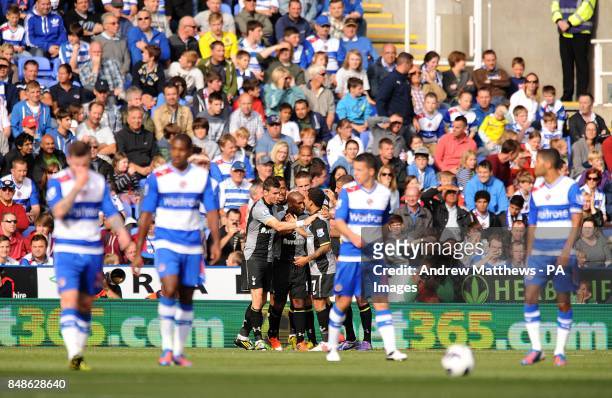 Tottenham Hotspur's Jermain Defoe celebrates scoring the opening goal of the game with his team-mates as Reading's players stand dejected