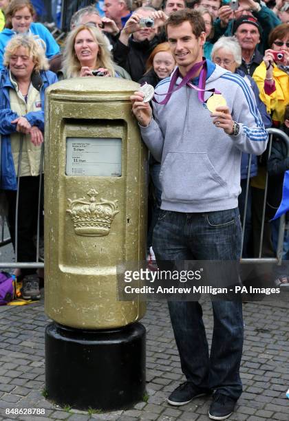 Olympic and US Open champion Andy Murray standing next to his gold painted post box during a walkabout in Dunblane, near Stirling in Scotland, on his...