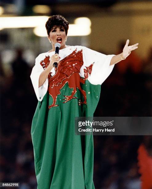 Photo of Shirley BASSEY, Shirley Bassey performing on stage wearing a Wales flag dress at the Opening ceremony of the 1999 Rugby Union World Cup