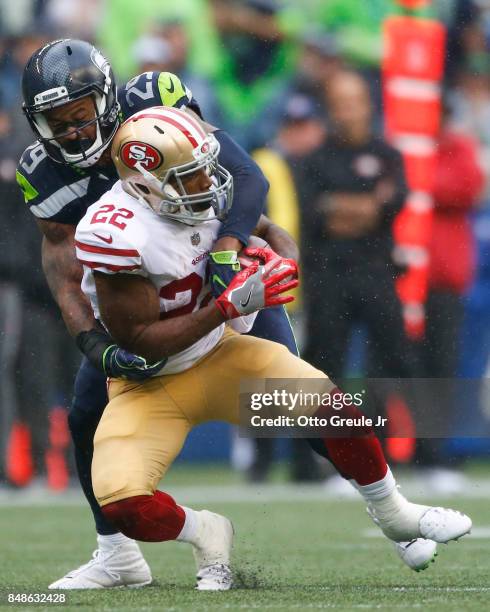 Running back Matt Breida of the San Francisco 49ers is tackled by free safety Earl Thomas of the Seattle Seahawks during the second half of the game...