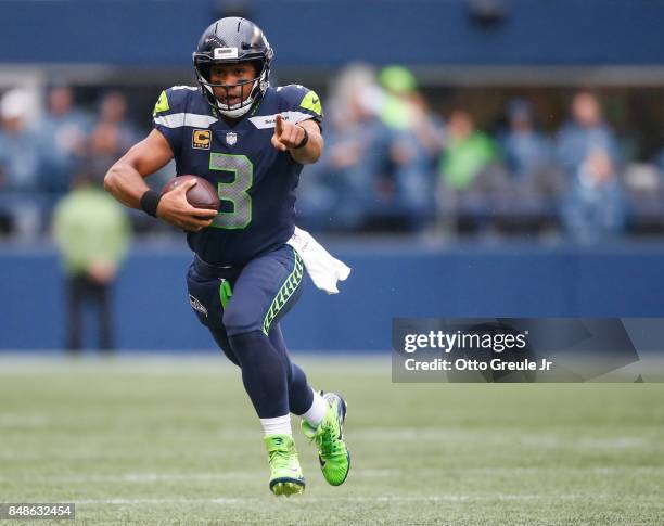 Quarterback Russell Wilson points as he takes off on a run against San Francisco 49ers during the the game at CenturyLink Field on September 17, 2017...