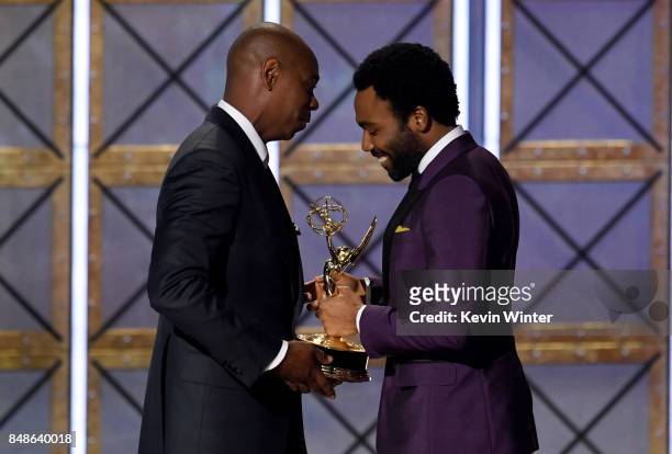 Actor/director Donald Glover accepts Outstanding Directing for a Comedy Series for 'Atlanta' from comedian Dave Chappelle onstage during the 69th...