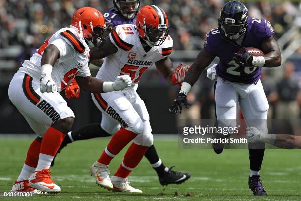 Running back Terrance West of the Baltimore Ravens rushes past cornerback Jamar Taylor of the Cleveland Browns in the first half at M&T Bank Stadium...