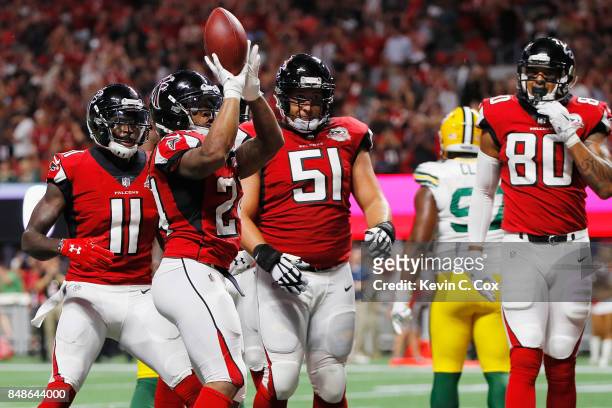Devonta Freeman of the Atlanta Falcons celebrates after scoring a 1-yard rushing touchdown during the first quarter against the Green Bay Packers at...