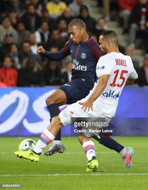 Kylian Mbappe of Paris Saint-Germain in action with Jeremy Morel of Olympique Lyonnais during the French Ligue 1 match between Paris Saint Germain...