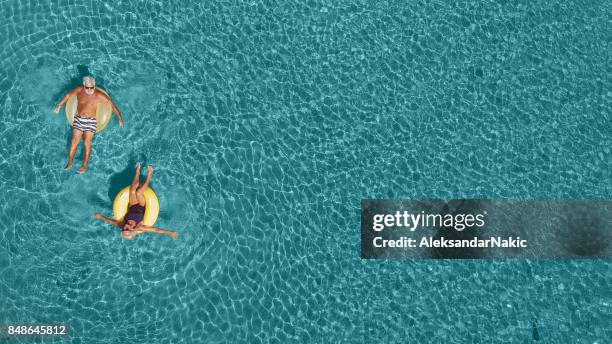 senior couple having fun in the sea - travel panoramic stock pictures, royalty-free photos & images