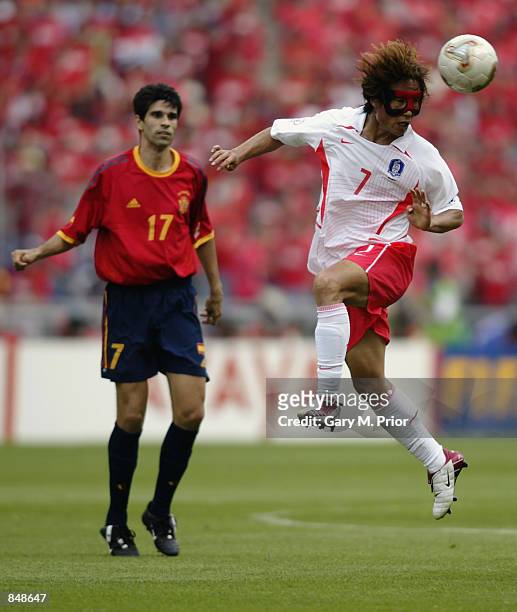 Tae Young Kim of South Korea wins a header from Juan Carlos Valeron of Spain during the FIFA World Cup Finals 2002 Quarter Finals match played at the...