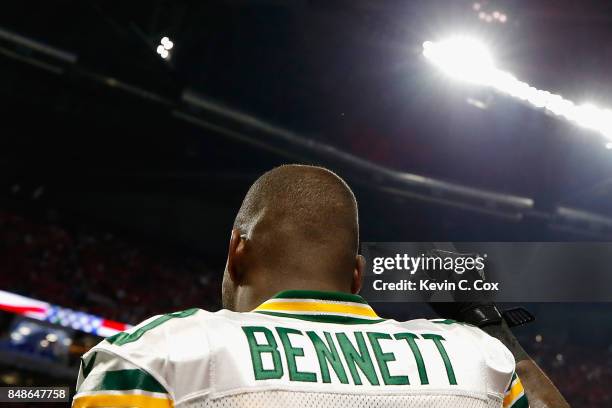 Martellus Bennett of the Green Bay Packers raises his fist during the national anthem prior to the game between the Green Bay Packers and the Atlanta...