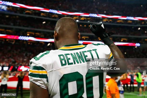 Martellus Bennett of the Green Bay Packers raises his fist during the national anthem prior to the game between the Green Bay Packers and the Atlanta...