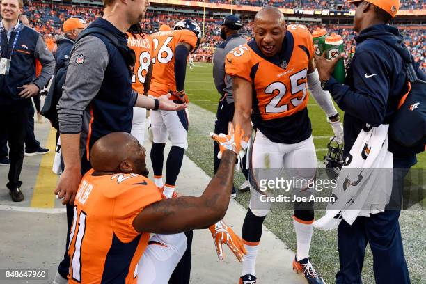 Aqib Talib of the Denver Broncos celebrates with Chris Harris after making a late pick six on a pass by Dak Prescott of the Dallas Cowboys during the...