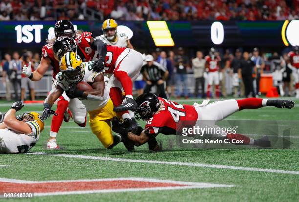 Ty Montgomery of the Green Bay Packers rushes for a 1-yard touchdown during the first quarter against the Atlanta Falcons at Mercedes-Benz Stadium on...