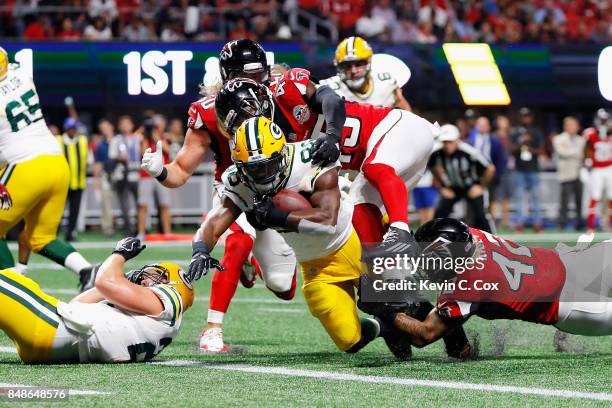 Ty Montgomery of the Green Bay Packers rushes for a 1-yard touchdown during the first quarter against the Atlanta Falcons at Mercedes-Benz Stadium on...