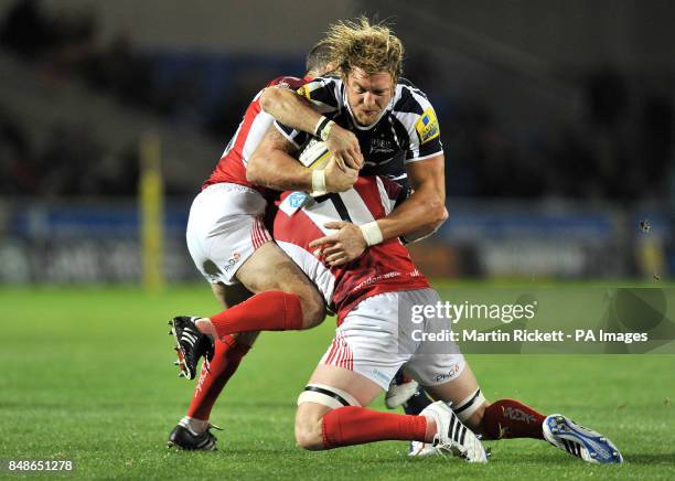 Sale Sharks Andy Powell is tackled by London Welsh's Gordon Ross and Michael Hills during the Aviva Premiership match at Salford City Stadium,...