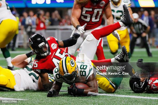 Ty Montgomery of the Green Bay Packers rushes for a 1-yard touchdown during the first quarter against the Atlanta Falcons at Mercedes-Benz Stadium on...