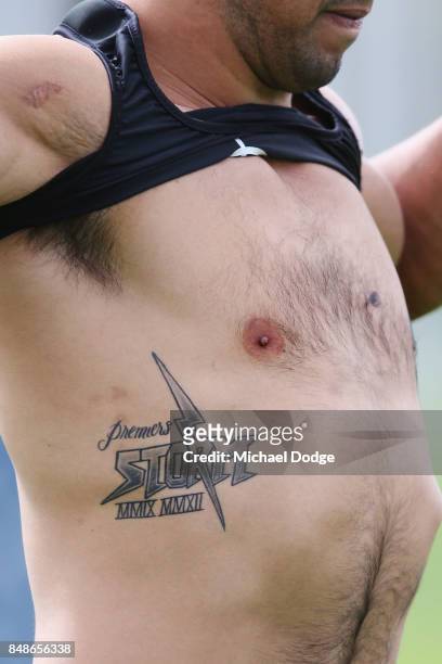 Will Chambers of the Storm shows off a premiership tattoo during a Melbourne Storm NRL training session at AAMI Park on September 18, 2017 in...