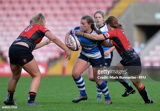 Rianna Manson of Darlington Mowden Park Sharks is tackled by Molly Morrissey and Gemma Sharples of Gloucester-Hartpury Women's RFC during the Womens...