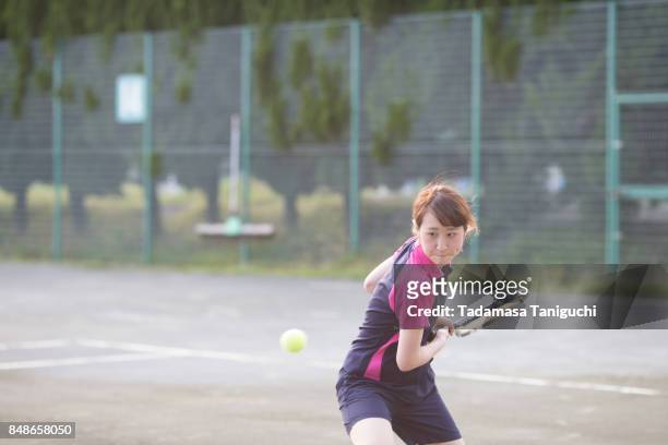 woman playing tennis - japanese tennis stock-fotos und bilder