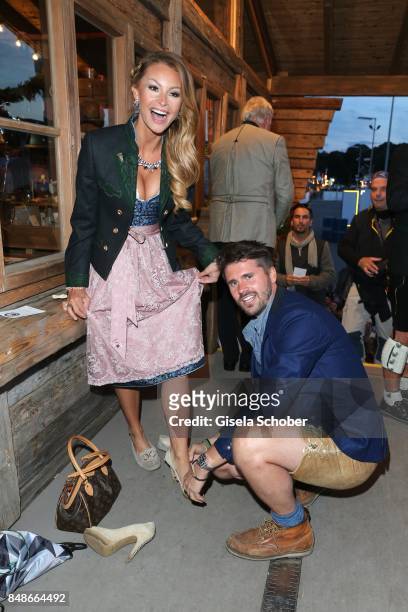 Thore Schoelermann and his girlfriend Jana Julie Kilka , helps her in her shoes, during the 'Almauftrieb' as part of the Oktoberfest 2017 at...