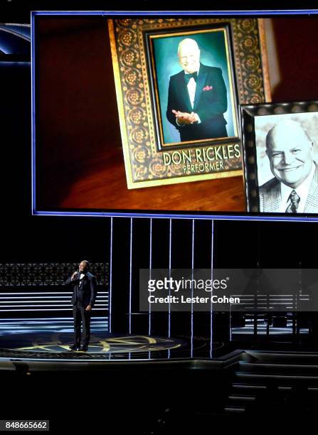 An image of late actor-comedian Don Rickles appears on a video screen while actor-singer Christopher Jackson performs a tribute onstage during the...