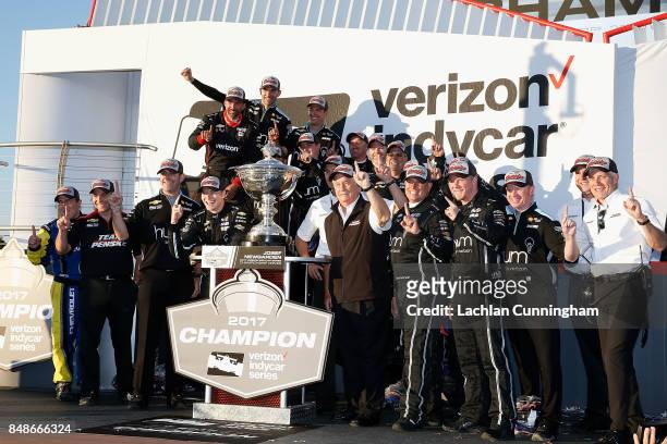 Josef Newgarden of the United States driver of the hum by Verizon Chevrolet and his team pose with the Astor Cup after winning the 2017 Verizon...