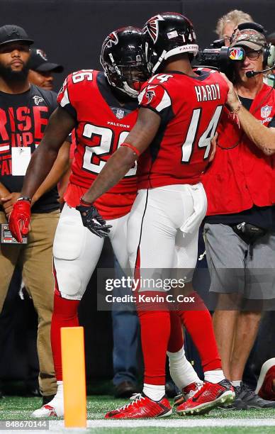 Tevin Coleman of the Atlanta Falcons celebrates with Justin Hardy after scoring a touchdown during the second quarter against the Green Bay Packers...