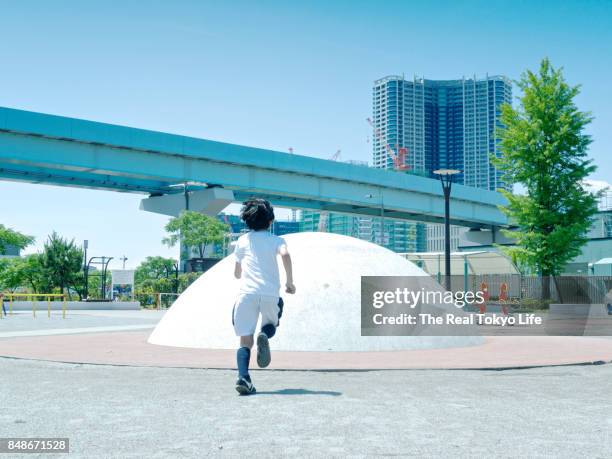 boy run a park in harumi tokyo. - harumi district tokyo stock pictures, royalty-free photos & images