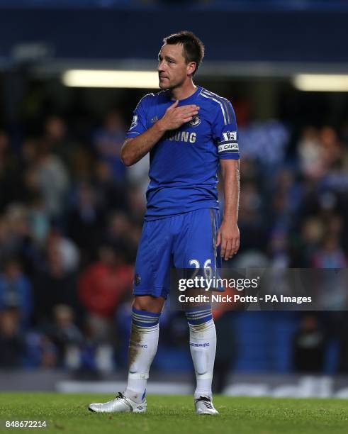 Chelsea's John Terry touches the club badge after the game