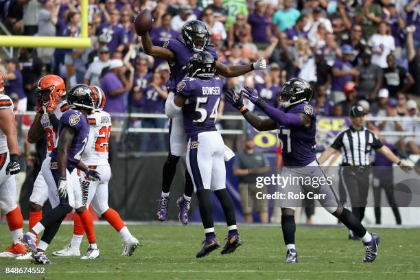 Cornerback Brandon Carr of the Baltimore Ravens celebrates with Tyus Bowser and C.J. Mosley after intercepting a Cleveland Browns pass late in the...