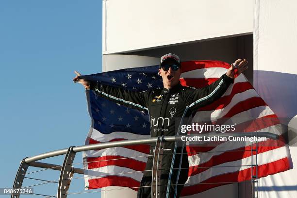 Josef Newgarden of the United States driver of the hum by Verizon Chevrolet celebrates on stage after winning the 2017 Verizon IndyCar series on day...