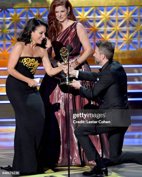 Actor Julia Louis-Dreyfus accepts the Outstanding Lead Actress in a Comedy Series for 'Veep' from actor Debra Messing and TV personality Chris...