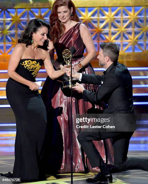 Actor Julia Louis-Dreyfus accepts the Outstanding Lead Actress in a Comedy Series for 'Veep' from actor Debra Messing and TV personality Chris...