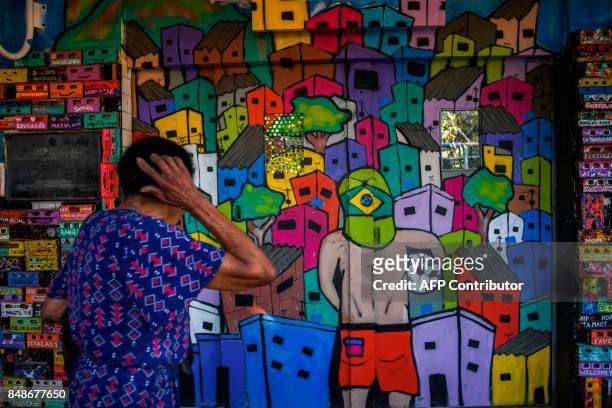 Woman waits for the elevator "Plano Inclinado" at the Santa Marta favela, the first to be pacified by the Pacifier Police Unit state programme to...