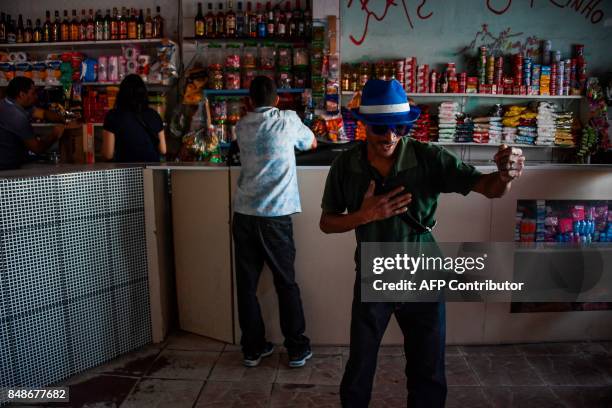 Man dances at a bar in the Santa Marta favela, the first to be pacified by the Pacifier Police Unit state programme to secure poor communities by...