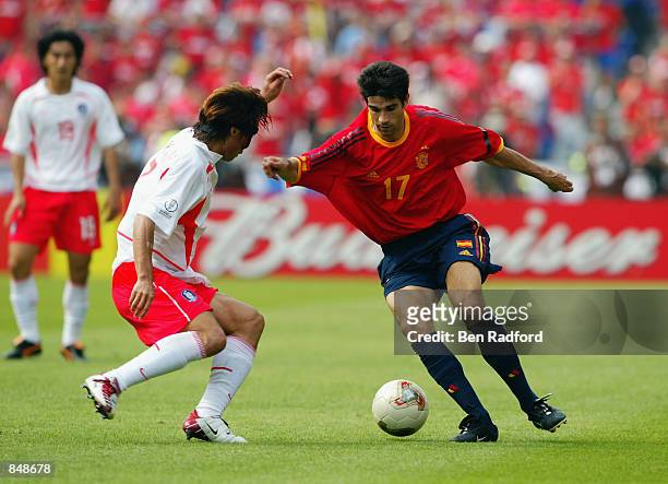 Juan Carlos Valeron of Spain takes the ball past Tae Young Kim of South Korea during the FIFA World Cup Finals 2002 Quarter Finals match played at...
