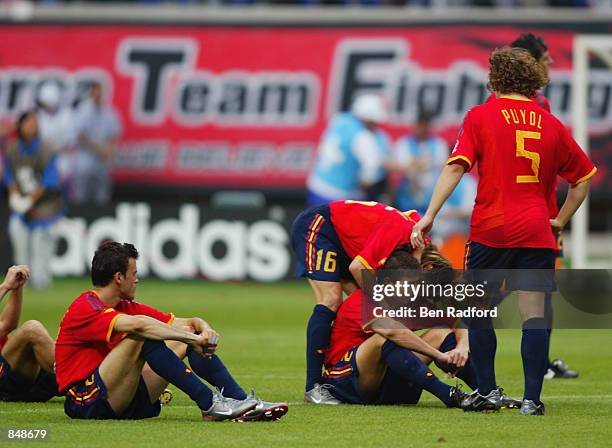 Joaquin of Spain is consoled by his team-mates as he misses the penalty that loses the penalty shoot-out during the FIFA World Cup Finals 2002...