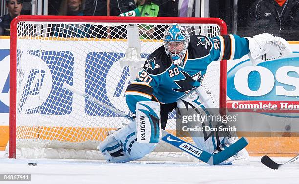 Evgeni Nabokov of the San Jose Sharks looks to snatch the puck during an NHL game against the Edmonton Oilers on February 17, 2009 at HP Pavilion at...