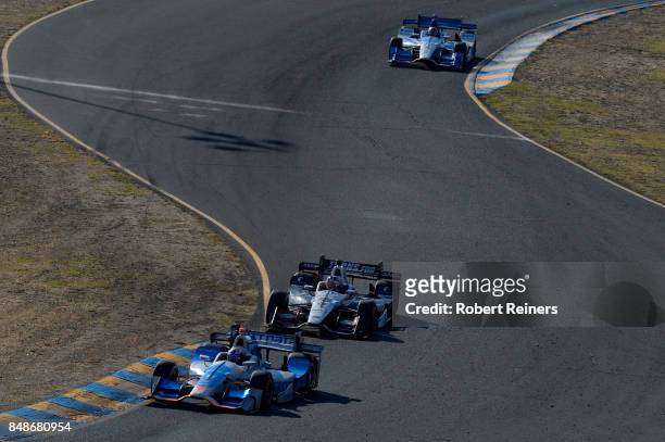 Scott Dixon, driver of the NTT Data Honda, leads Graham Rahal, driver of the United Rentals/SoldierStrong Honda, and Marco Andretti, driver of the...