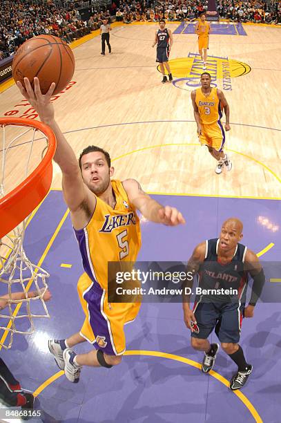 Jordan Farmar of the Los Angeles Lakers goes up for a layup while Maurice Evans of the Atlanta Hawks looks on during their game at Staples Center on...