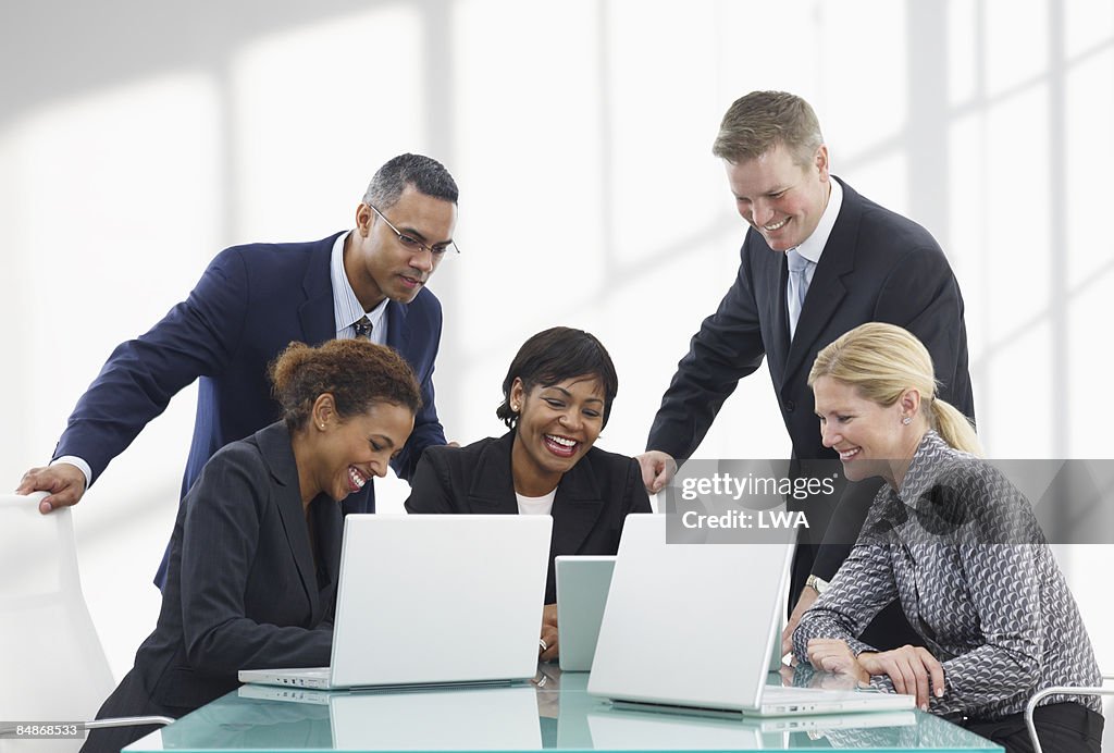 Modern Business Meeting with Laptops